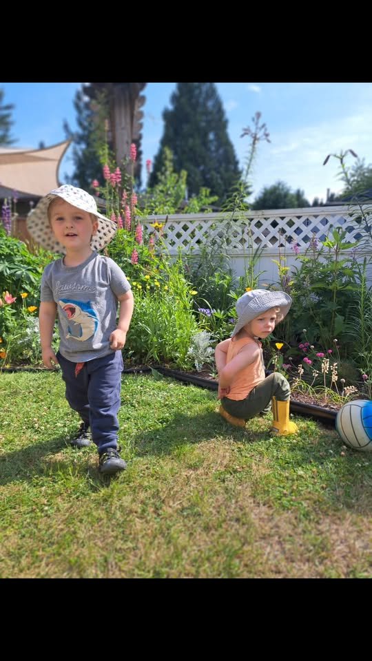Two children exploring in the garden
