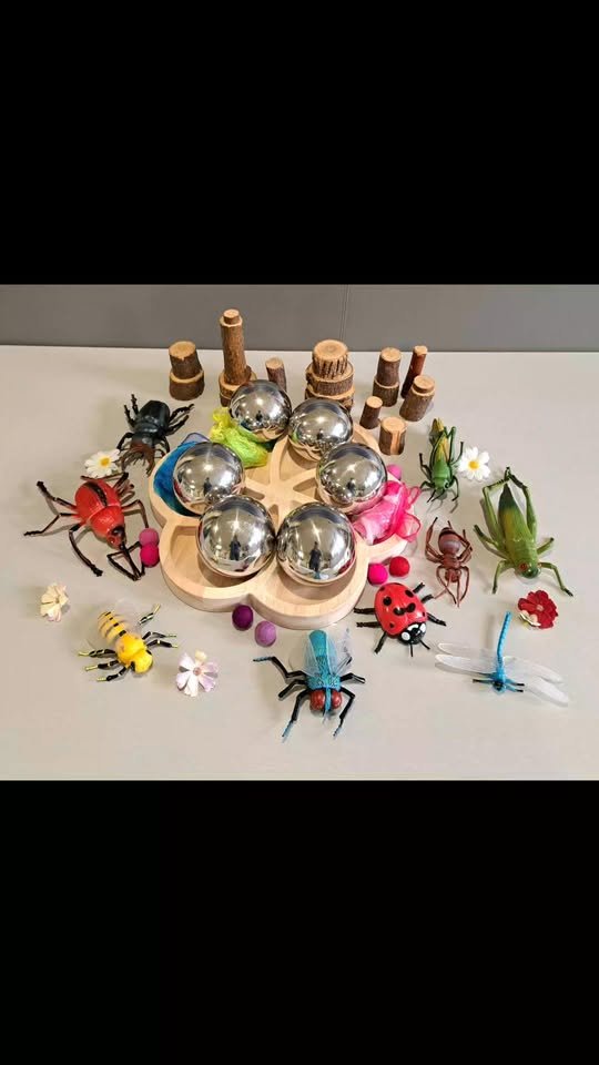 Sensory play with metallic spheres and toy bugs