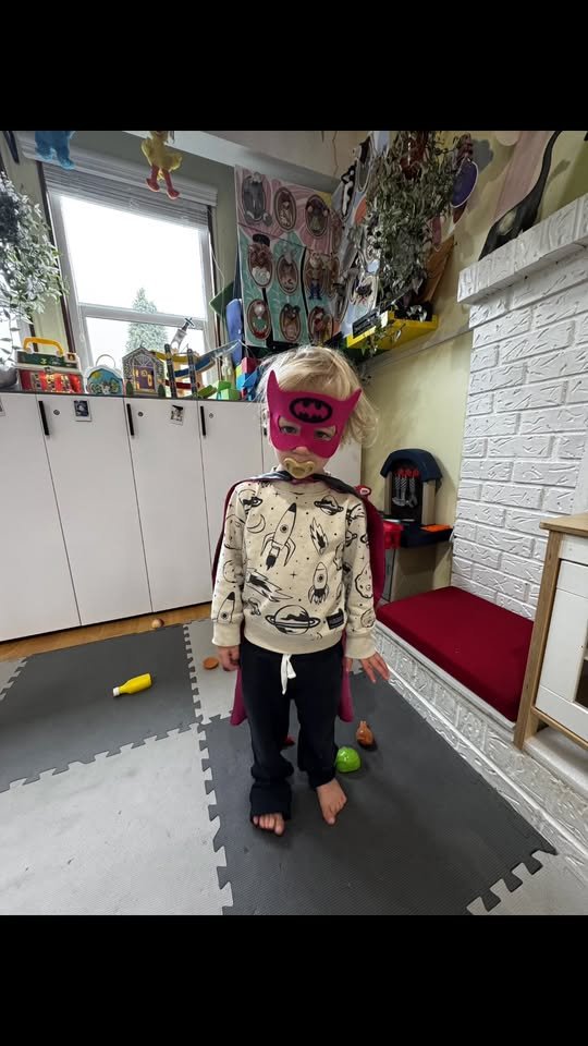 Child in superhero cape and mask