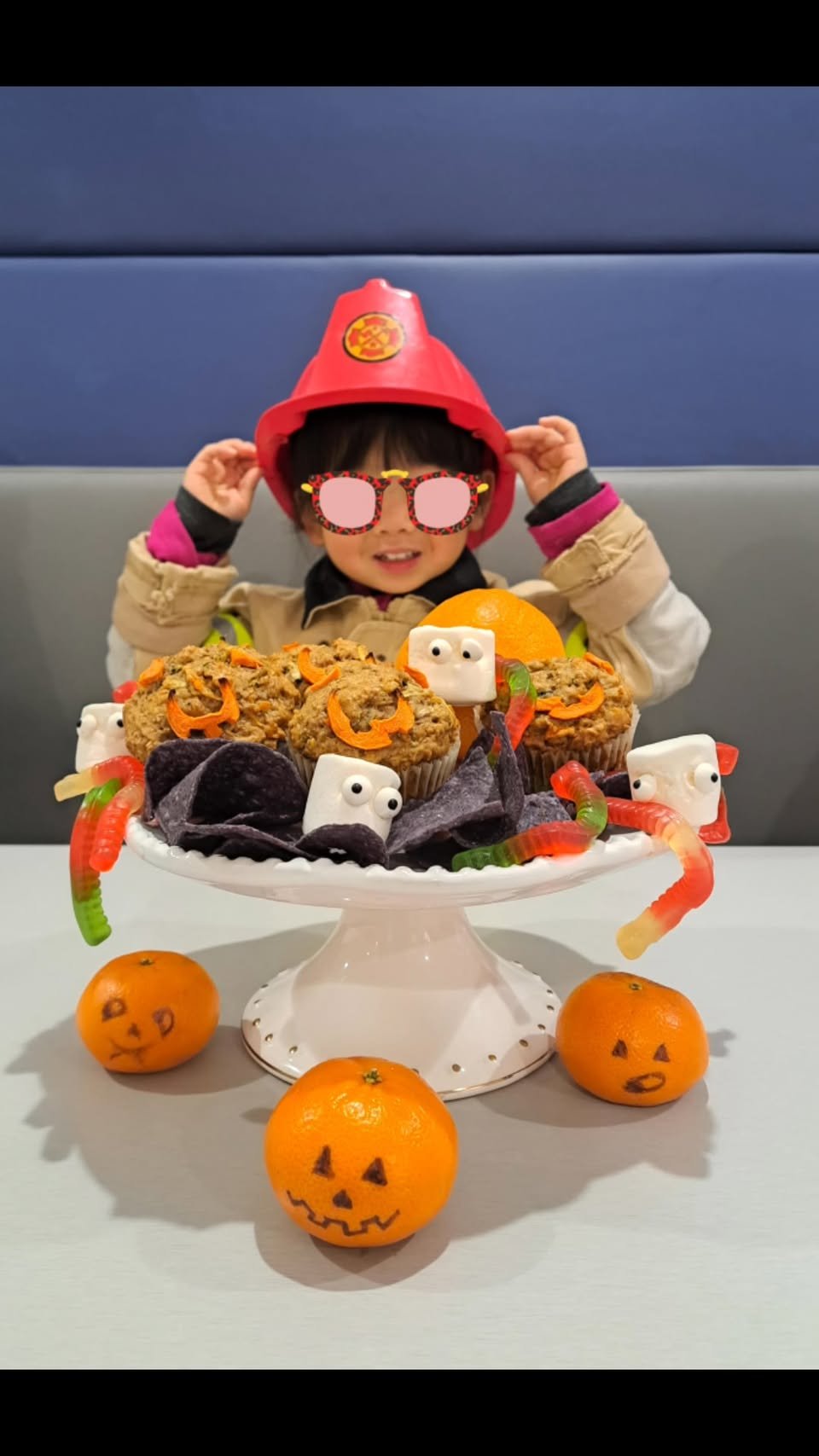 Halloween cupcakes with child in firefighter hat