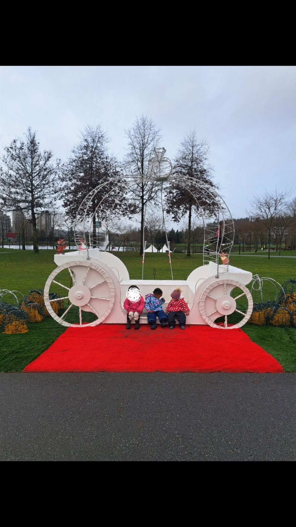 Children sitting in a decorative white carriage
