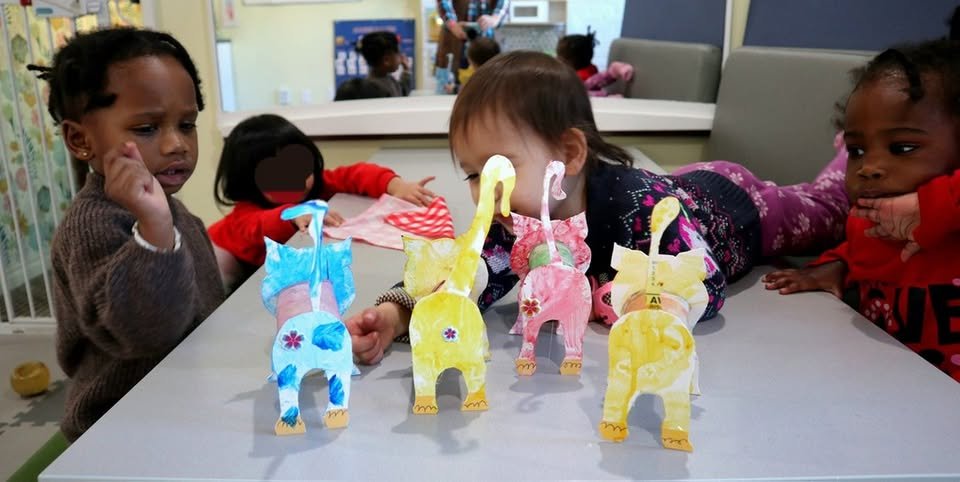 Children playing with crafted paper cats