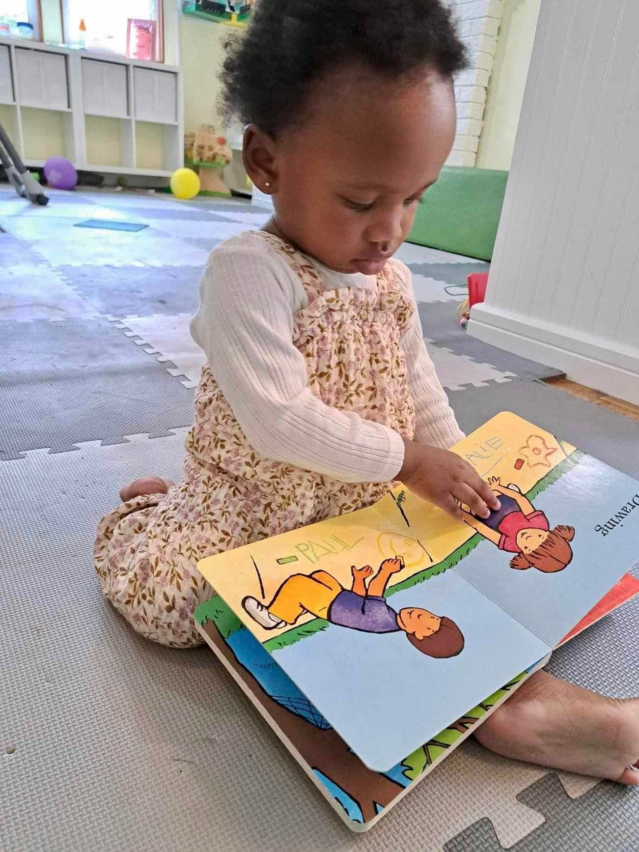 Baby reading a drawing book